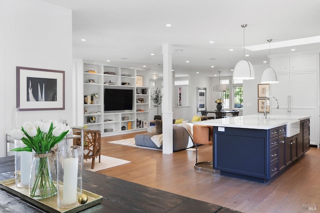1071 Bale Ln, Calistoga, CA 94515 - kitchen with a sink, open floor plan, blue cabinetry, and wood finished floors
