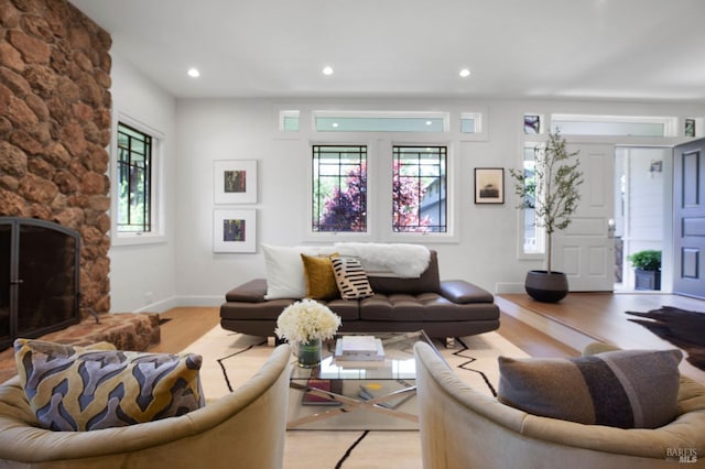 1071 Bale Ln, Calistoga, CA 94515 - living room with a stone fireplace, baseboards, recessed lighting, and wood finished floors