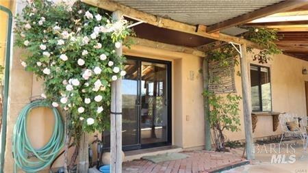 view of exterior entry with stucco siding
