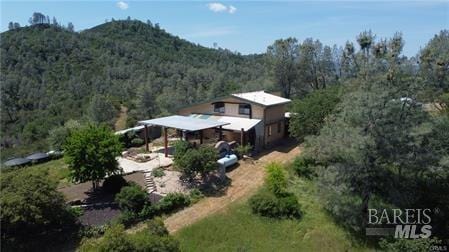 aerial view featuring a mountain view and a wooded view