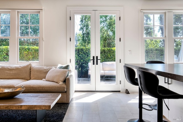 doorway with tile patterned floors and french doors