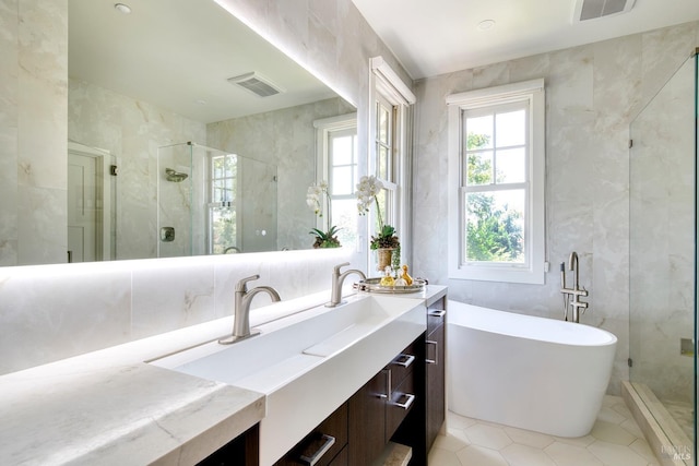 full bathroom featuring vanity, visible vents, a stall shower, tile patterned flooring, and a soaking tub