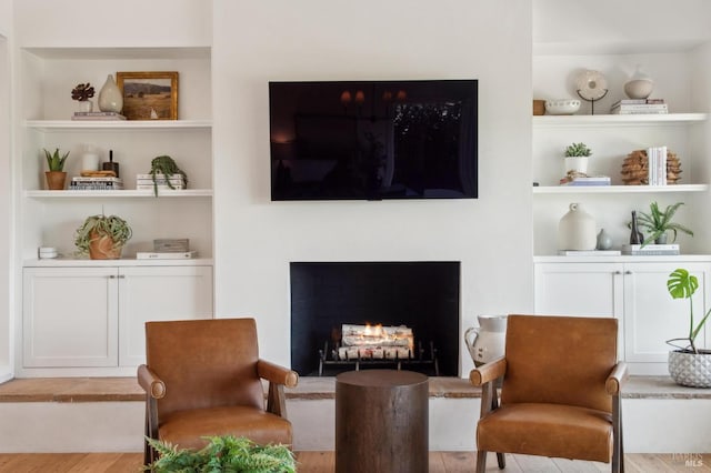 271 Via La Paz Rd, Greenbrae, CA 94904 - living room featuring a lit fireplace, built in features, and wood finished floors