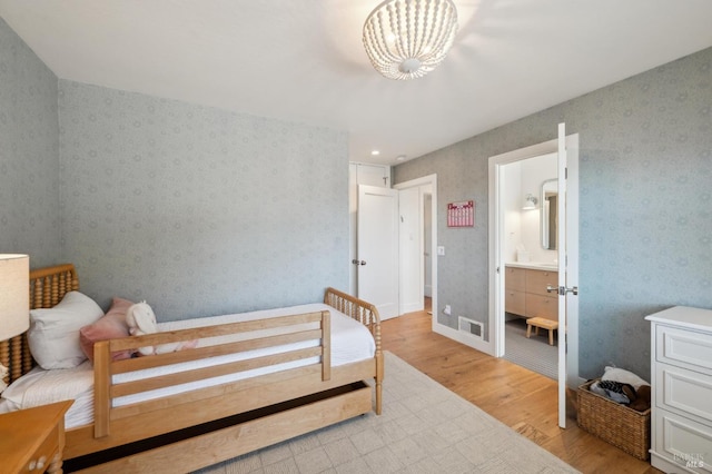 271 Via La Paz Rd, Greenbrae, CA 94904 - bedroom with light wood finished floors, wallpapered walls, connected bathroom, and visible vents