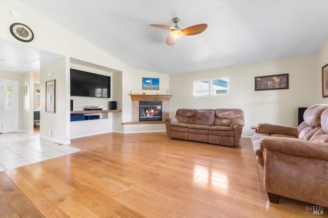 19475 Old Creek Rd, Hidden Valley Lake, CA 95467 - living room with light wood-style floors, a ceiling fan, healthy amount of natural light, a glass covered fireplace, and lofted ceiling