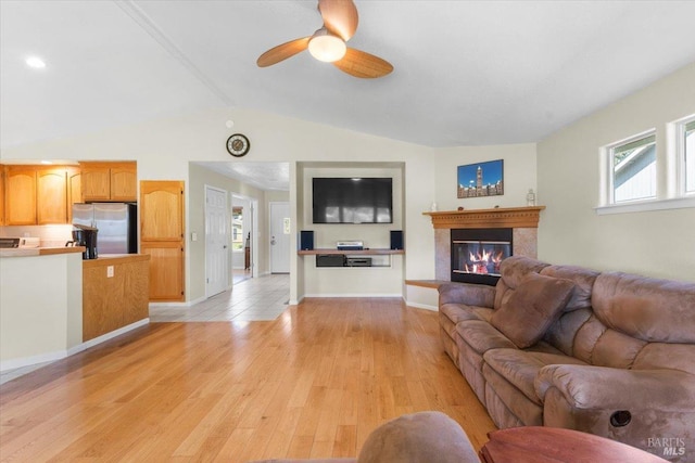 19475 Old Creek Rd, Hidden Valley Lake, CA 95467 - living area featuring lofted ceiling, a glass covered fireplace, light wood-type flooring, ceiling fan, and baseboards