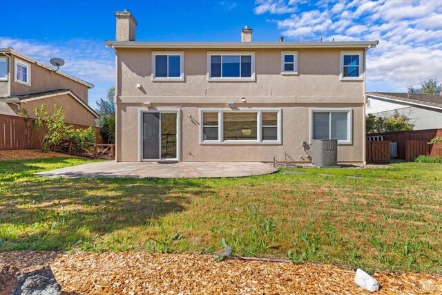 back of property featuring a patio area, stucco siding, and a chimney