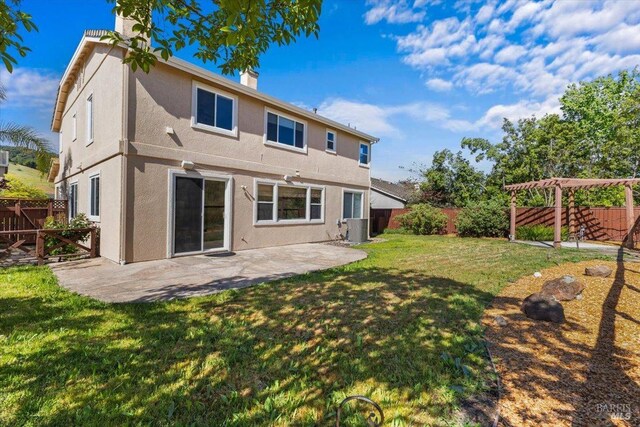 rear view of property featuring a chimney, stucco siding, a patio area, and central AC