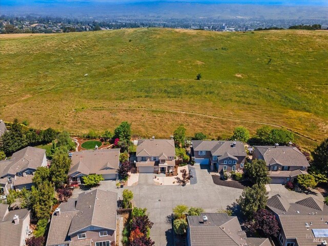 aerial view of property and surrounding area with nearby suburban area