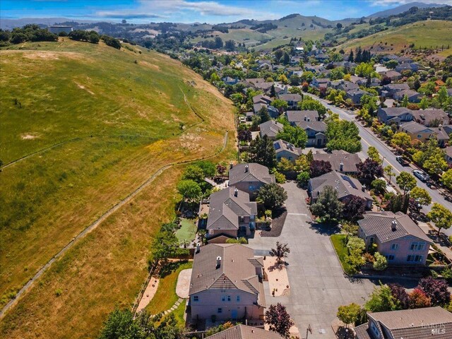 aerial view of residential area featuring mountains
