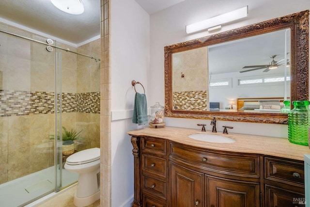full bath with vanity, toilet, a shower stall, and ceiling fan