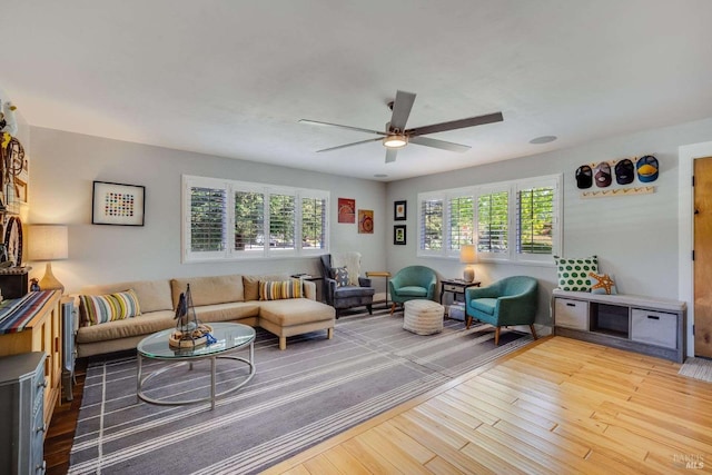 living area with ceiling fan and wood finished floors