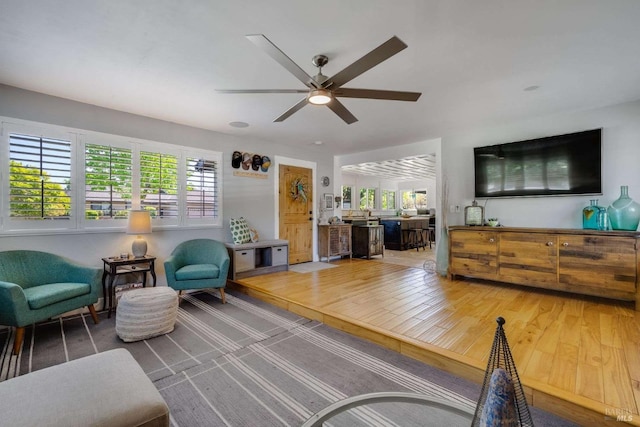 interior space with ceiling fan, a wealth of natural light, and wood finished floors