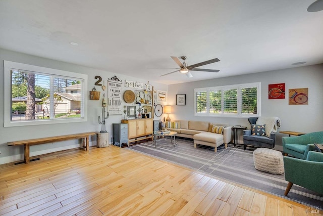 living area with visible vents, ceiling fan, and hardwood / wood-style flooring