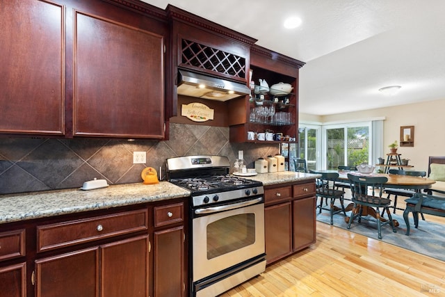 824 W St, Petaluma, CA 94952 - kitchen with gas stove, under cabinet range hood, light wood-style floors, tasteful backsplash, and open shelves