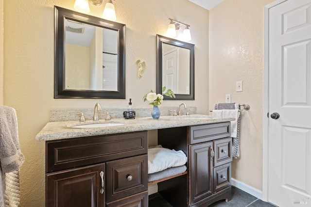 824 W St, Petaluma, CA 94952 - bathroom with double vanity, tile patterned floors, a textured wall, and baseboards