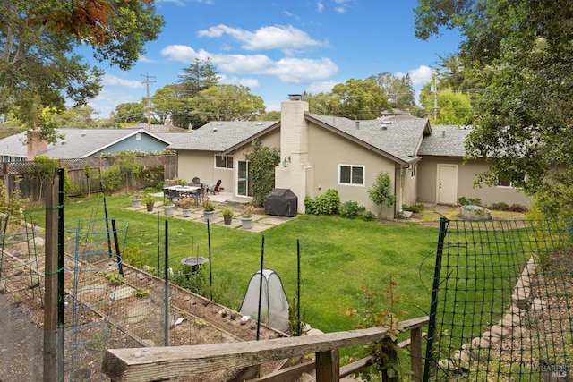 824 W St, Petaluma, CA 94952 - rear view of house featuring a vegetable garden, stucco siding, a patio, a chimney, and a shingled roof