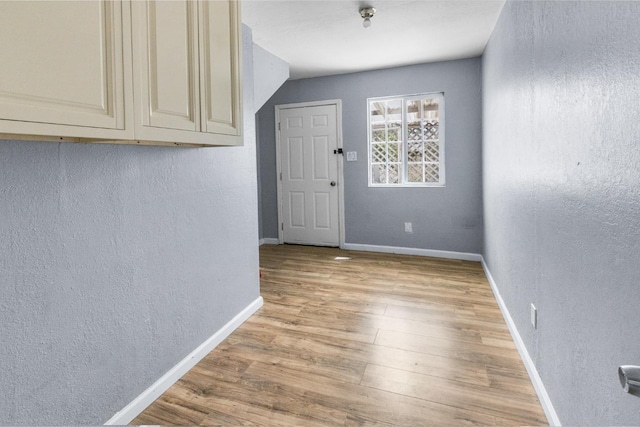 2931 Elm Ave, Merced, CA 95348 - unfurnished dining area with a textured wall, light wood-style flooring, and baseboards