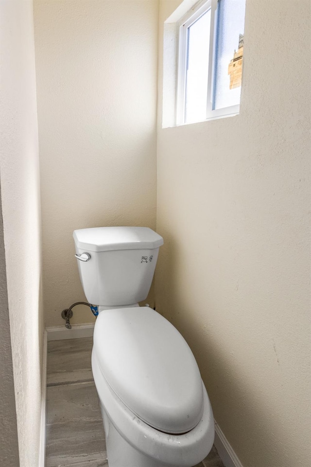 2931 Elm Ave, Merced, CA 95348 - bathroom with toilet, baseboards, and wood finished floors