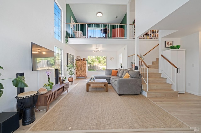 624 N Regatta Dr, Vallejo, CA 94591 - living room with stairs, a high ceiling, baseboards, and wood finished floors