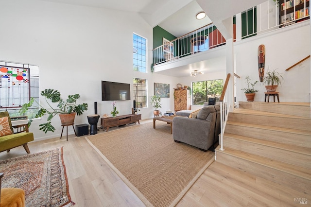 624 N Regatta Dr, Vallejo, CA 94591 - living area featuring stairs, baseboards, high vaulted ceiling, and wood finished floors