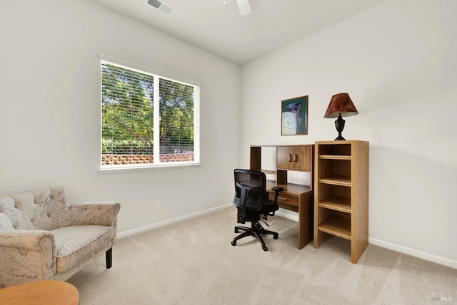 office area featuring light carpet, baseboards, a ceiling fan, and visible vents