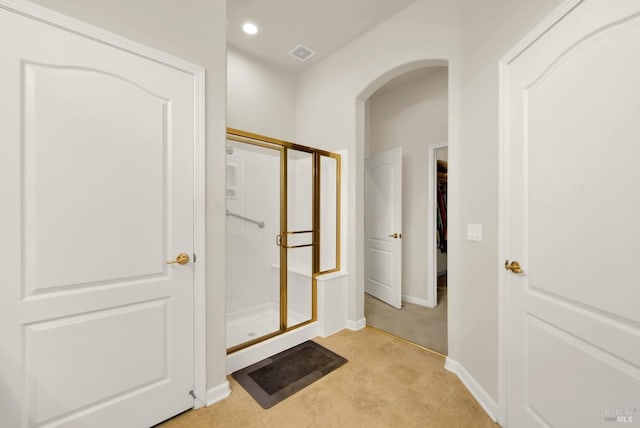 full bathroom with recessed lighting, baseboards, visible vents, a shower stall, and a spacious closet
