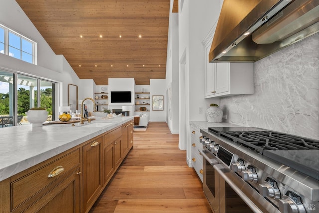 2509 Madrona Ave, Saint Helena, CA 94574 - kitchen with double oven range, a sink, high vaulted ceiling, extractor fan, and brown cabinets
