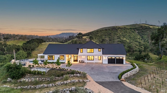 2509 Madrona Ave, Saint Helena, CA 94574 - view of front of property with an attached garage, a mountain view, metal roof, and aphalt driveway