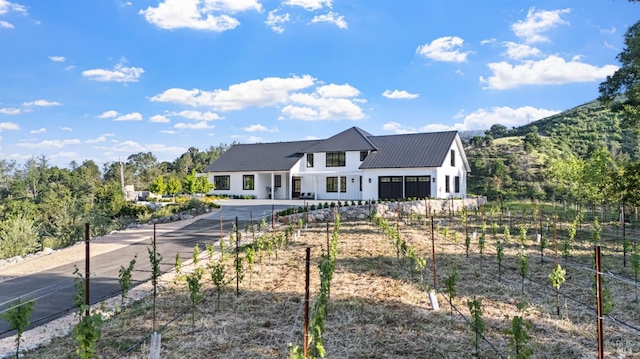 2509 Madrona Ave, Saint Helena, CA 94574 - view of front facade featuring board and batten siding, driveway, fence, and metal roof