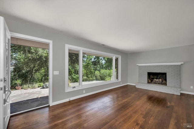 3257 State Highway 128, Calistoga, CA 94515 - unfurnished living room featuring wood finished floors, healthy amount of natural light, a brick fireplace, and baseboards