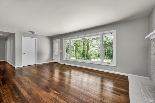 3257 State Highway 128, Calistoga, CA 94515 - unfurnished living room featuring baseboards, wood finished floors, and a brick fireplace