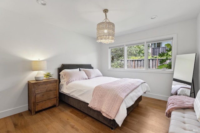 46 Lower N Ter, Tiburon, CA 94920 - bedroom with wood finished floors, baseboards, and a notable chandelier