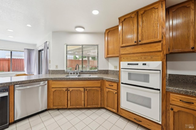 151 Doncaster Dr, Vallejo, CA 94591 - kitchen featuring brown cabinets, a sink, dark countertops, double oven, and stainless steel dishwasher