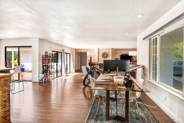 home office with wood finished floors, baseboards, and recessed lighting