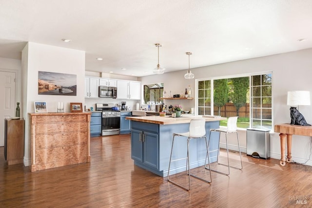kitchen featuring white cabinetry, appliances with stainless steel finishes, blue cabinetry, and dark wood-style floors
