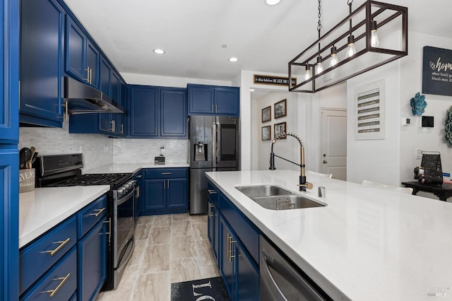 kitchen featuring under cabinet range hood, appliances with stainless steel finishes, blue cabinets, and a sink