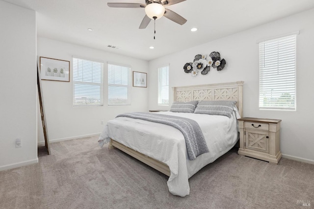 bedroom with light carpet, baseboards, a ceiling fan, and visible vents