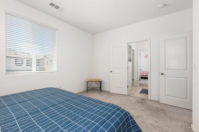 bedroom featuring visible vents, baseboards, and carpet floors