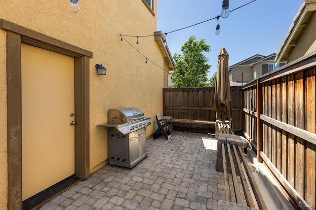 view of patio / terrace featuring grilling area and fence