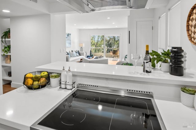 room details with stove, light countertops, and recessed lighting