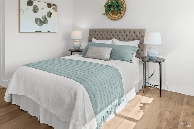 bedroom featuring wood finished floors and baseboards