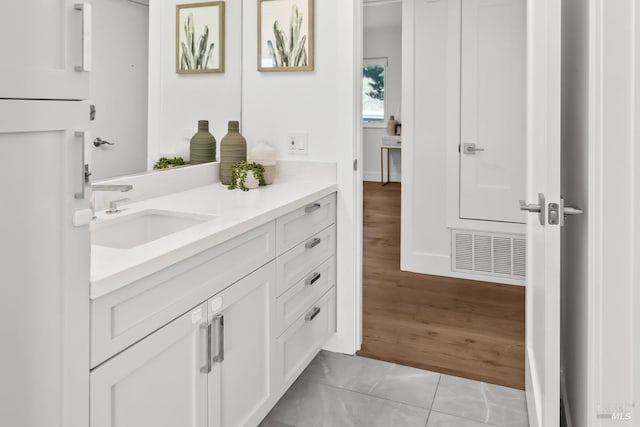 bathroom featuring vanity, visible vents, and wood finished floors