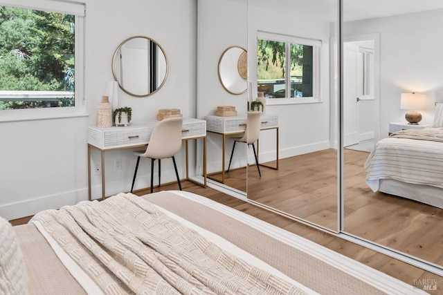 bedroom with baseboards, a closet, and wood finished floors