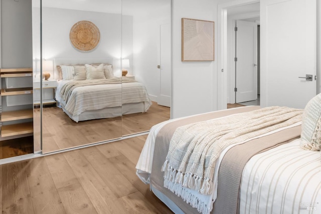 bedroom with baseboards and wood finished floors