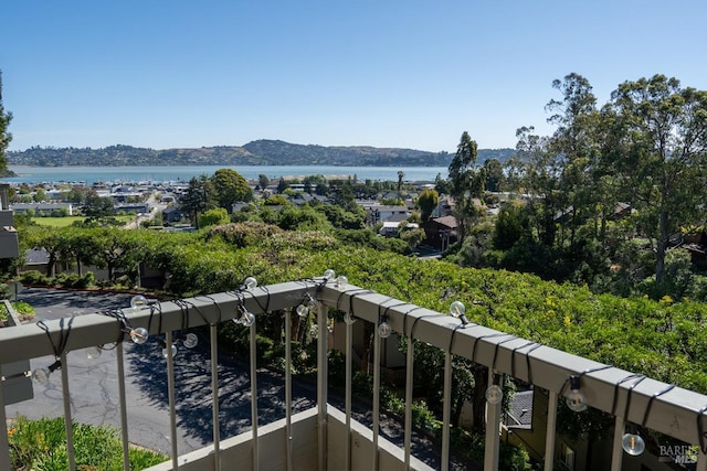 balcony featuring a water and mountain view