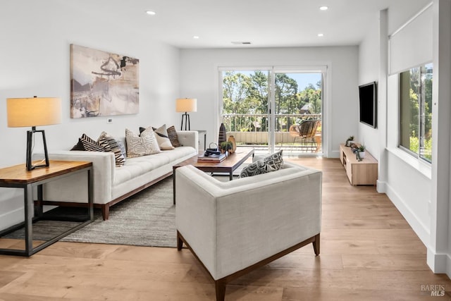 living area featuring light wood-style flooring, visible vents, and recessed lighting