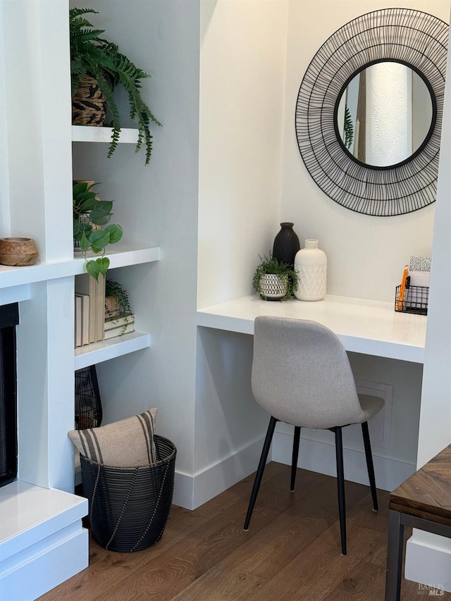 office with built in desk and wood finished floors