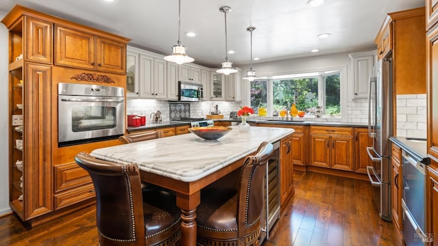 2267 Westside Rd, Healdsburg, CA 95448 - kitchen featuring appliances with stainless steel finishes, brown cabinets, dark wood-style flooring, recessed lighting, and decorative backsplash