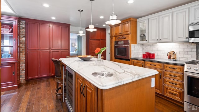 2267 Westside Rd, Healdsburg, CA 95448 - kitchen featuring appliances with stainless steel finishes, a kitchen island, dark wood-type flooring, wine cooler, and recessed lighting
